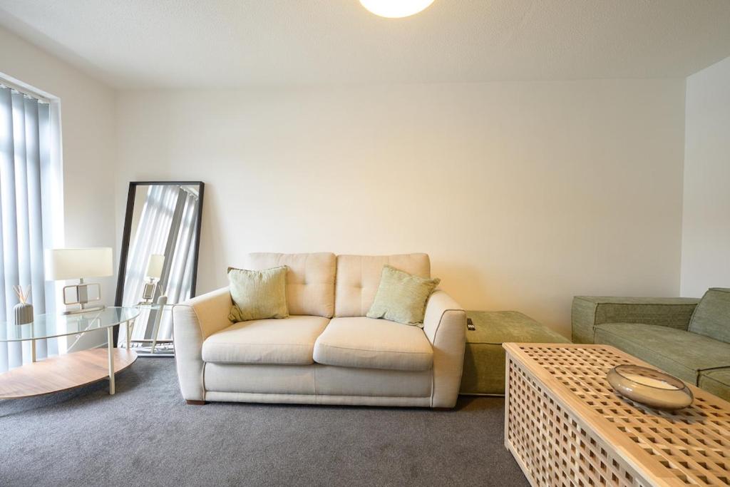 a living room with a couch and a coffee table at Comfortable 3-BR House in Malvern Link
