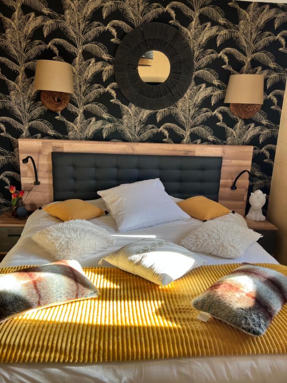 a bedroom with a bed with a mirror on the wall at Chambre chaleureuse in Grosley-sur-Risle
