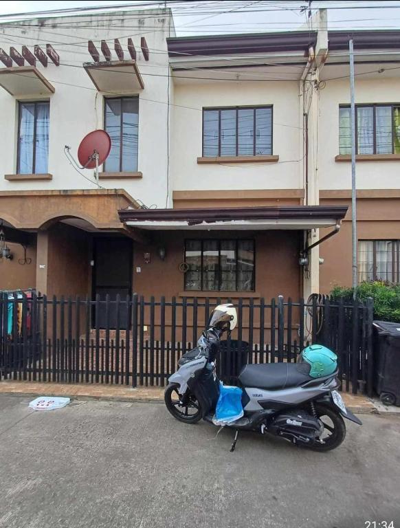a motorcycle parked in front of a building at Townhouse in Agus