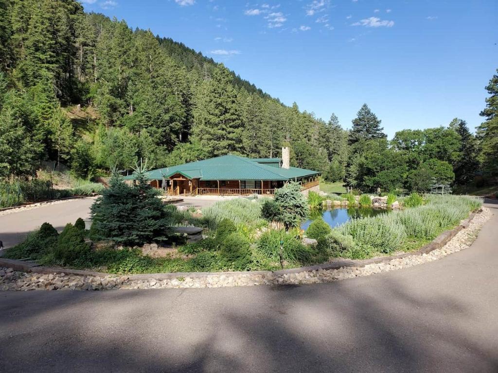 a house with a lake in the middle of a road at Skyline Ranch in High Rolls