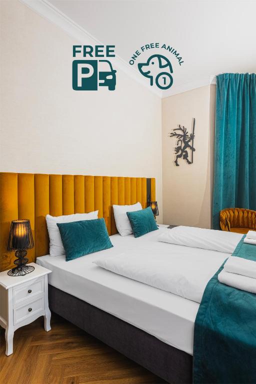 a bedroom with two beds and a sign that reads free pc at Perła Sudetów by Stay inn Hotels in Karpacz