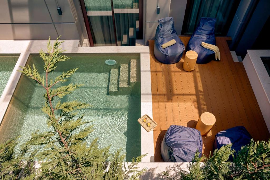 a house with a swimming pool with chairs and a table at Zeus Thessaloniki Lazart in Thessaloniki