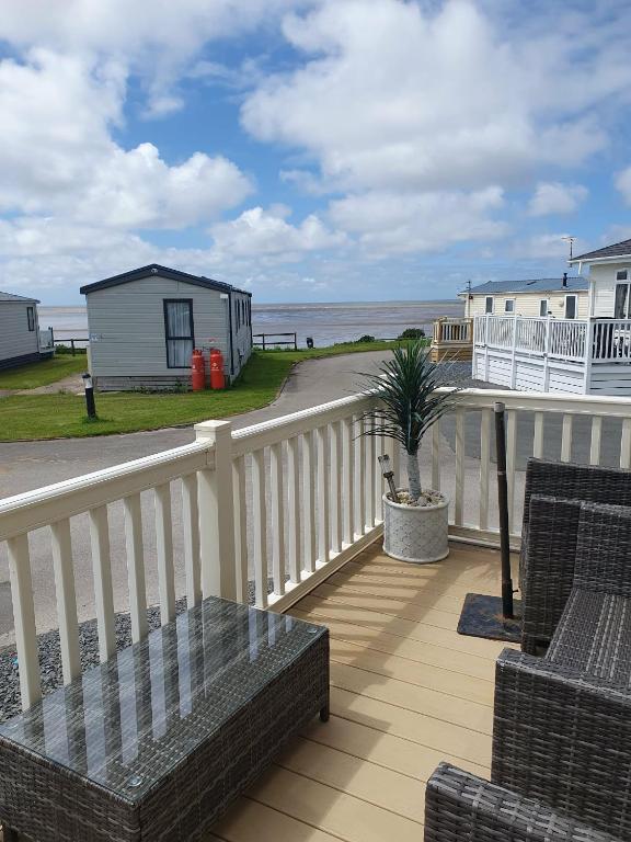 a balcony with chairs and a view of the beach at Jasper Lodge in Morecambe