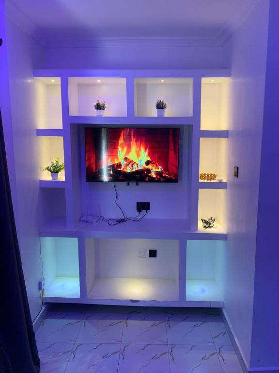 a fireplace in a living room with a fire in it at Kisumu gateway 2br in Kisumu