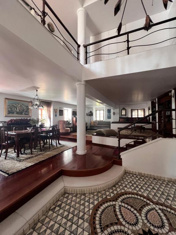 a living room with a staircase and a dining room at Αρχοντικό Λίθος in Kastoria