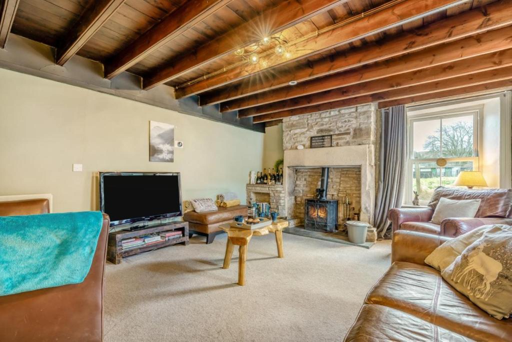 a living room with a couch and a fireplace at 4 Bed in Nenthead oc-c34669 in Nenthead