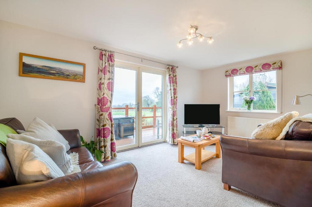 a living room with a couch and a television at 2 Bed in Coaley oc-s34729 in Coaley