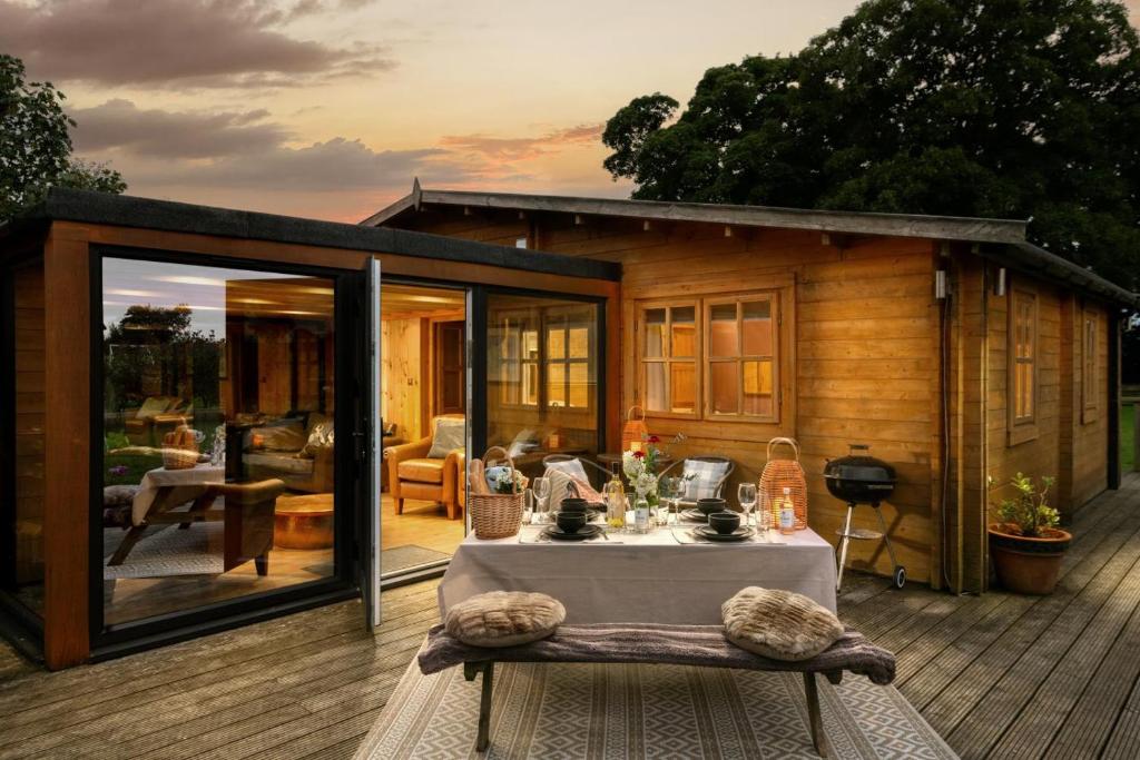 a house with a table on a deck at 6 Bed in Alkham oc-p34791 in Swingfield