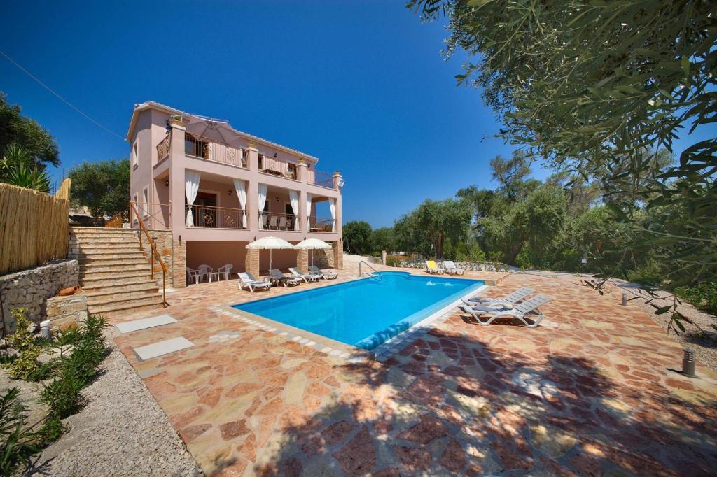 an external view of a house with a swimming pool at Villa Androniki in Longós