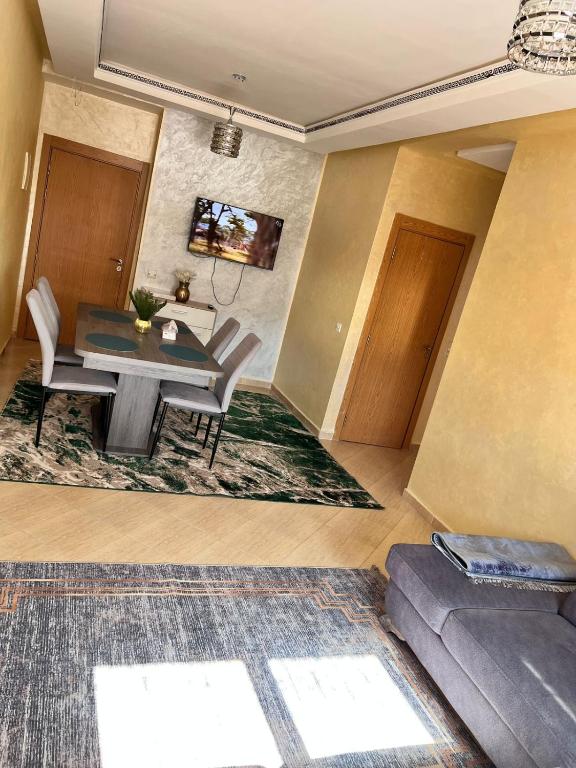 a dining room with a table and a couch at Apartmen rentals with M Z in Marrakesh