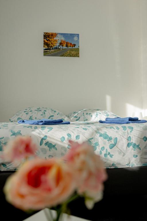 a bed in a room with flowers on it at Apartmány Beseda in Jablonec nad Nisou