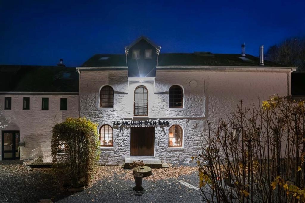 a white building with a tower on top of it at L'Atelier du Moulin d'en Bas in Saint-Hubert