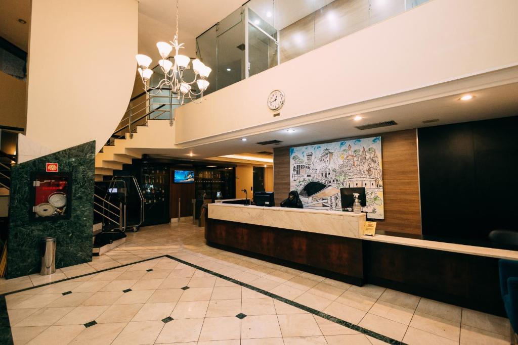 a lobby of a restaurant with a reception counter at Eco Stay in Curitiba