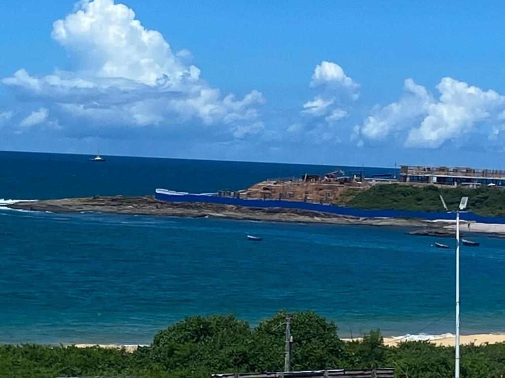 an island in the ocean with a train on it at Mar e Descanso in Guarapari