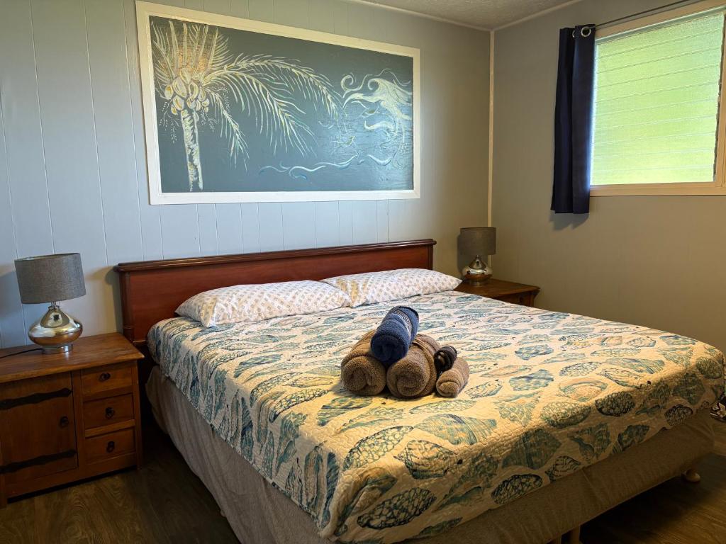 a stuffed animal is laying on a bed at Rainbow Ohana, unit 2 in Hilo