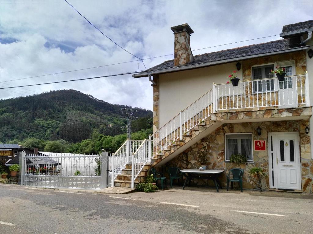 a house with a staircase and a table outside at Apartamentos Casa Alvarina - Luarca in Cortina