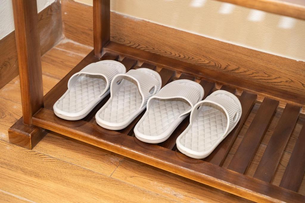 four pairs of shoes in a wooden shelf at Sunset Garden in Ninh Binh