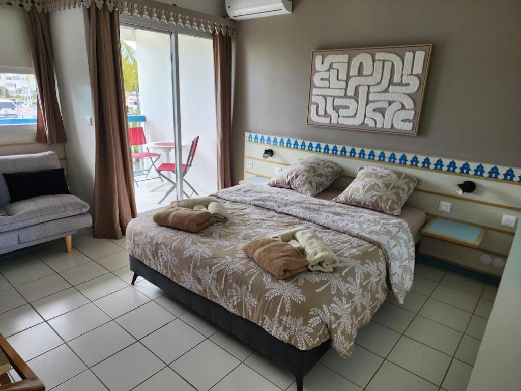 a bedroom with a bed with two stuffed animals on it at Marina View in Les Trois-Îlets