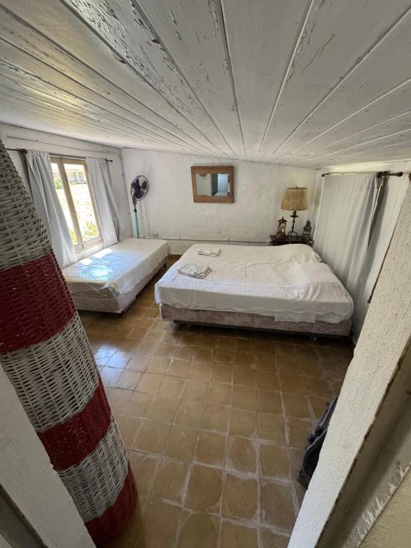 a bedroom with two beds in a room at Casa del monte in Carmen de Areco