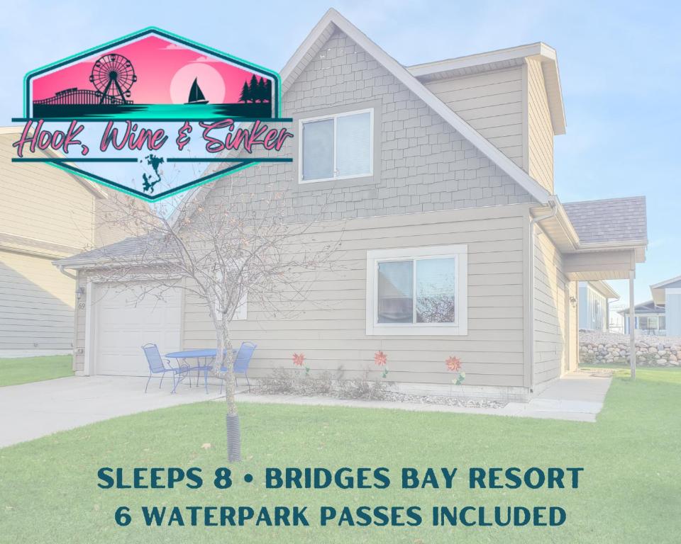 a house with a sign in front of it at Bridges Bay Vacation Cabin 69 in Arnolds Park