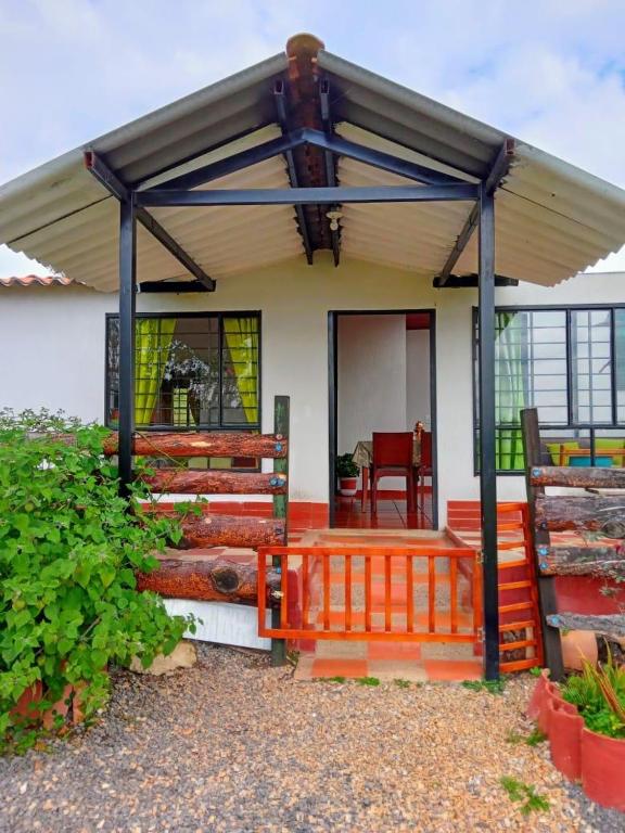 a small house with a roof and a porch at Finca La Milagrosa in Cómbita