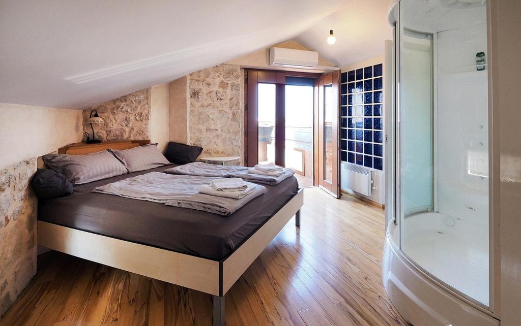 a bedroom with a large bed and a shower at VISTA ART sea view in Funtana