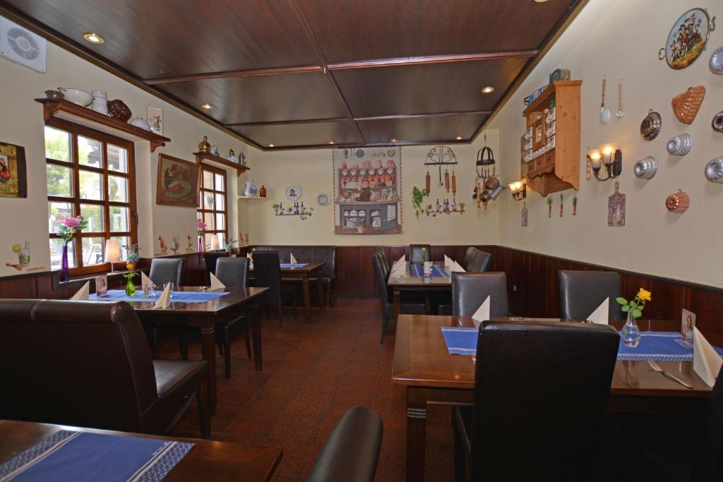 a restaurant with wooden tables and chairs and plates on the wall at Ferienwohnung Neptun am Brunnenplatz Zentrum in Büsum
