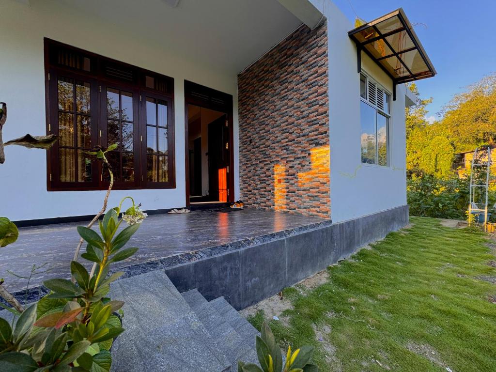 a house with a pathway leading to the front door at Mist Cave Ella in Etimale