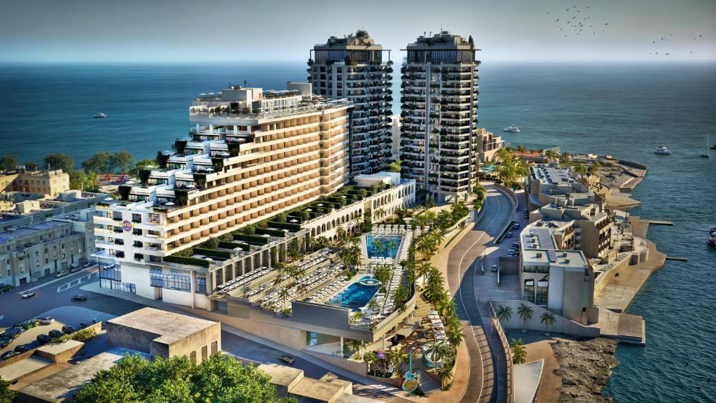 an aerial view of a resort near the ocean at Hard Rock Hotel Malta in St. Julianʼs