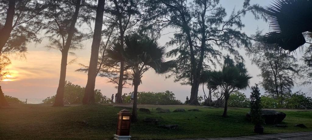 a fire hydrant in a park with palm trees at Sea heaven Phuket Naiyang in Phuket