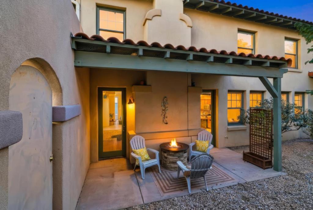 a patio with two chairs and a fire pit at Kindroot 5 in Tucson