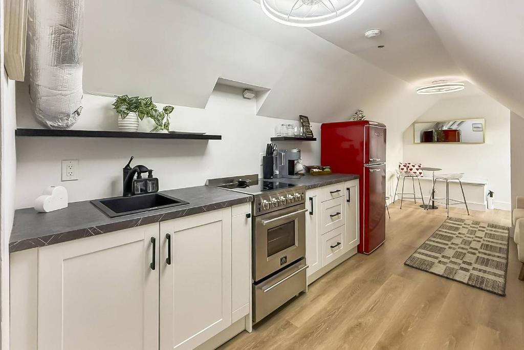 a kitchen with a red refrigerator and white cabinets at Harbor Haven, Apt #4 - 2BR/1BA in Stamford