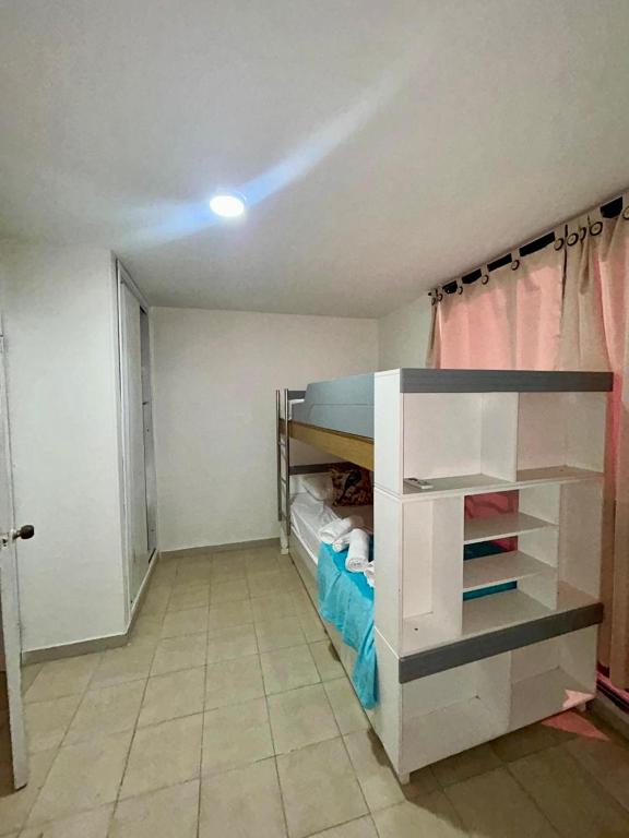 a room with a bunk bed and a closet at Casa del Prado in Santa Marta
