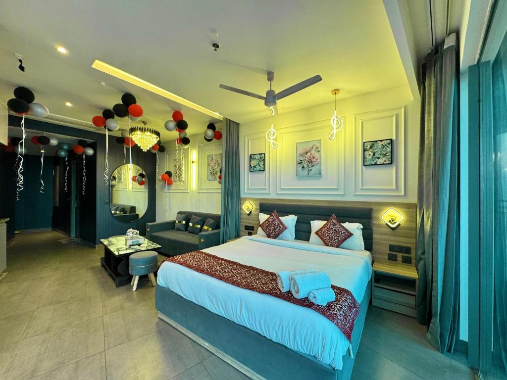 a bedroom with a large bed and a living room at Mulberry Homes Supernova in Noida