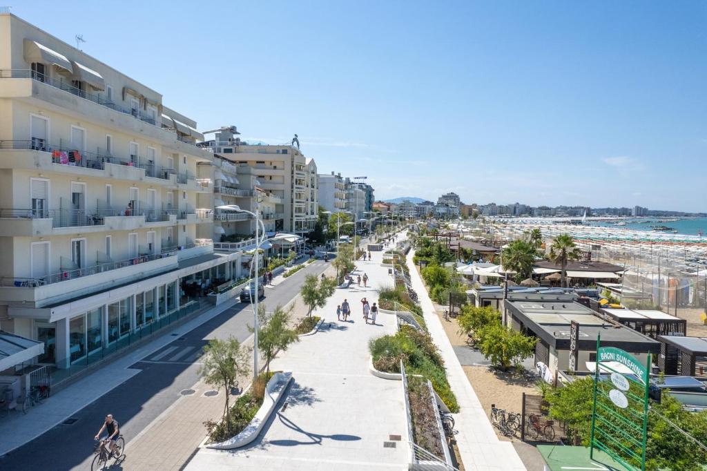 a city street with buildings and a beach at Hotel Bellevue in Cattolica