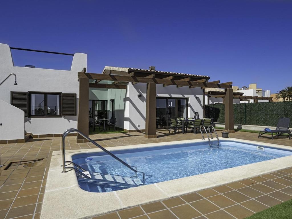 a swimming pool in front of a house at GuestReady - Luxury Villa with Pool in Antigua