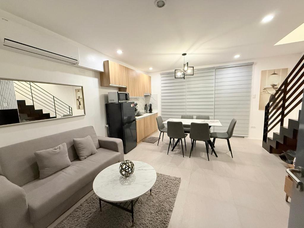 a living room with a couch and a table at Kaizen Urban Retreat - Elevate Your Stay in Calo