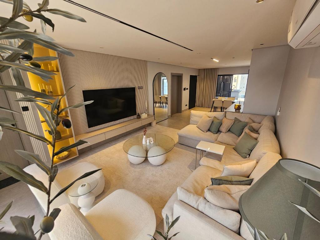 a living room with a couch and a tv at شقق باطلالات بانوراميه in Riyadh
