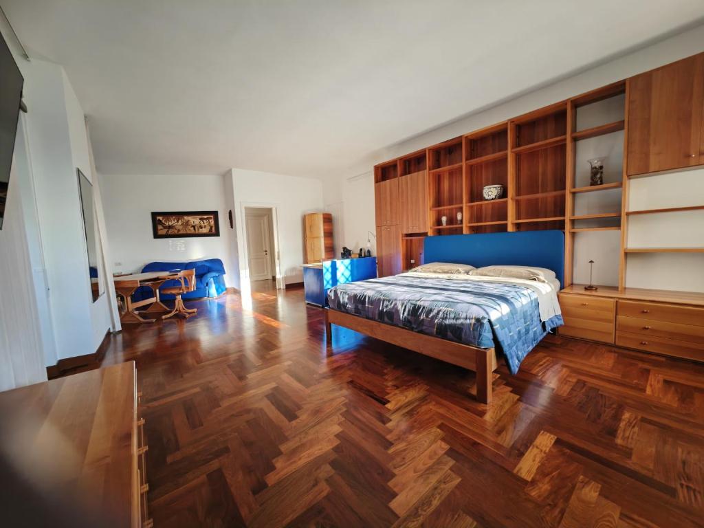 a bedroom with a bed and a wooden floor at Blue emotion, into wellness & wilderness in Albano Laziale