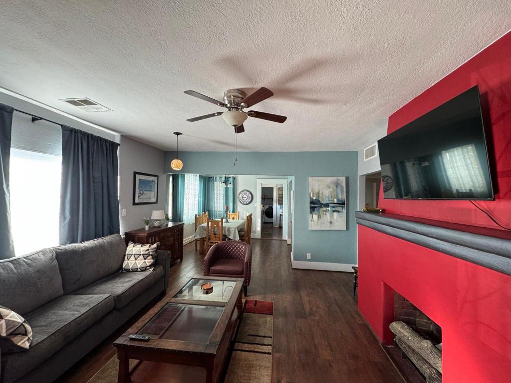 a living room with a couch and a ceiling fan at Casa 131 in Tucson