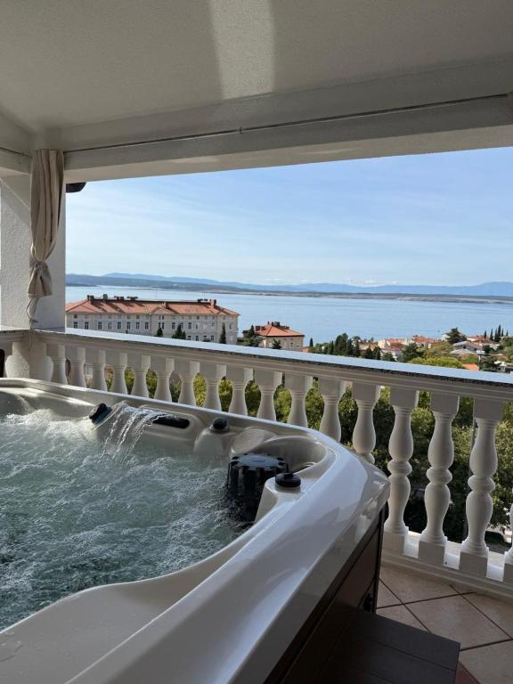 a bath tub with a view of the ocean at Apartment Ornik in Crikvenica