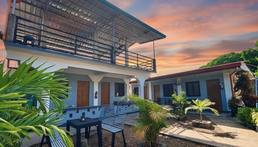a house with a balcony and a table at Angel Gabriel Homestay in Coron