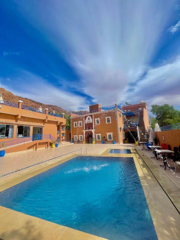 a large swimming pool in front of a building at Riad lina in Tafraout