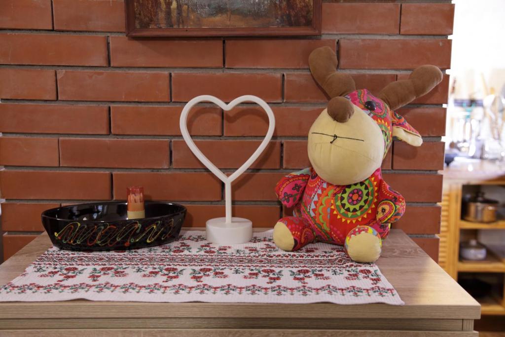 a teddy bear sitting on a table with a heart instrument at Minimax in Odesa