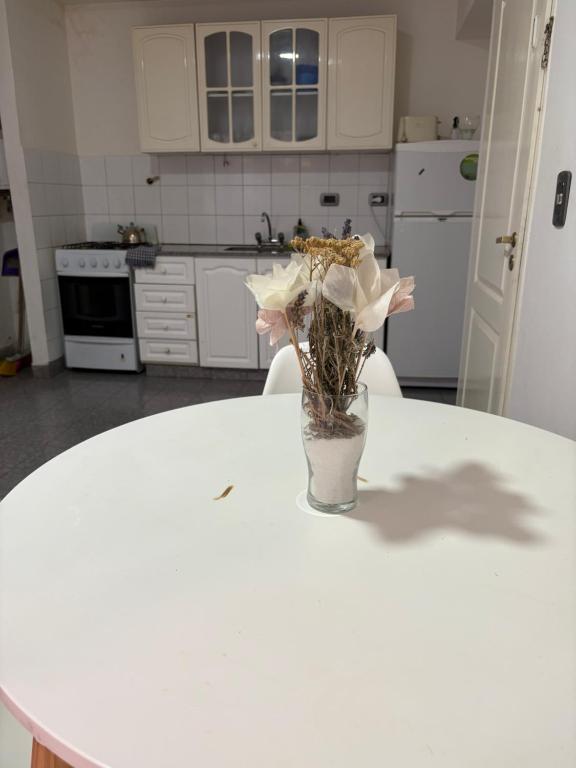a vase of flowers sitting on a table in a kitchen at Santa Genoveva in Neuquén