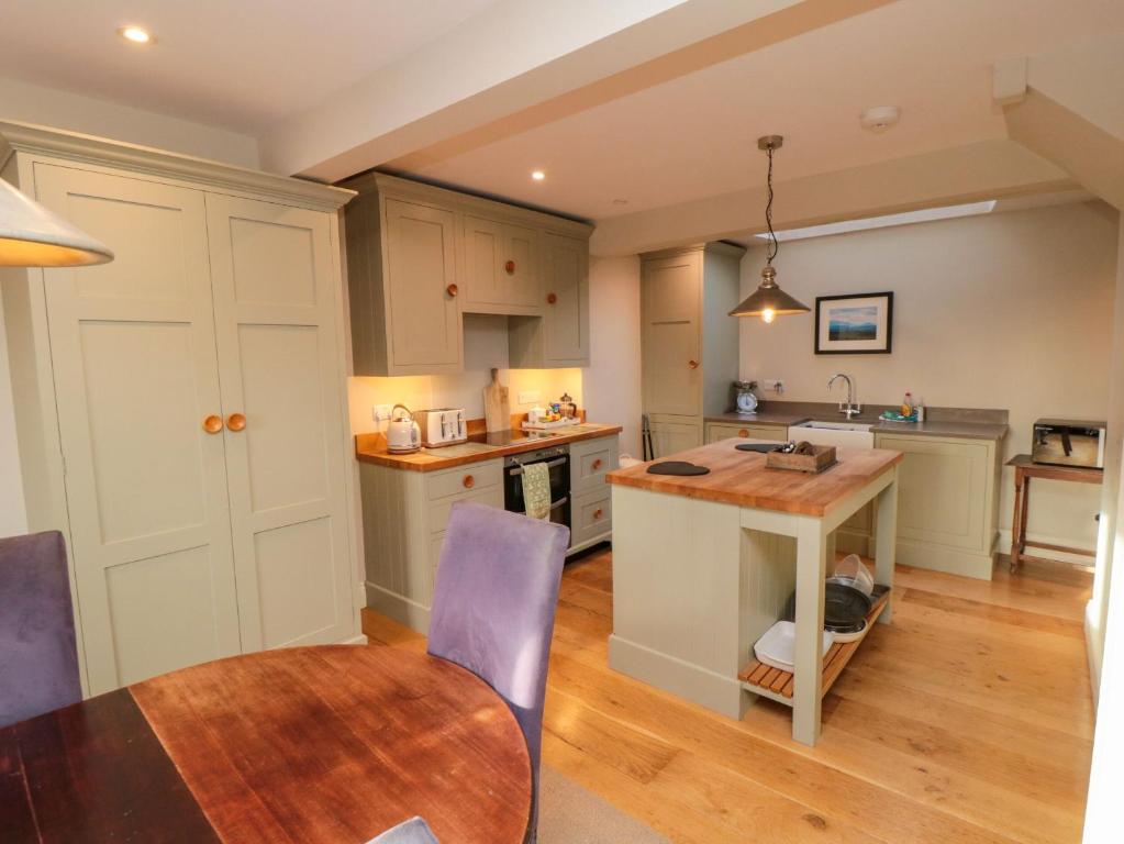 a kitchen with a table and a dining room at St Anthonys in York