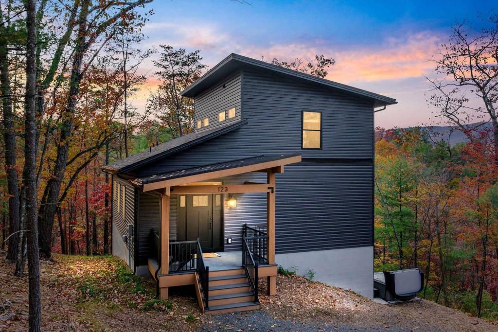 a small black house in the middle of the woods at Valley View in Basye
