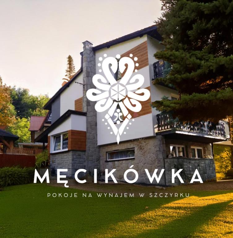 a sign on the side of a house at Męcikówka in Szczyrk
