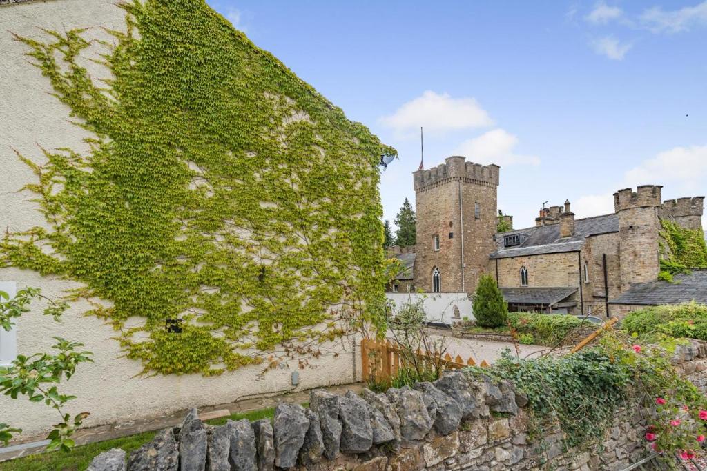 an ivy covered wall in front of a castle at 2 Bed in Brough oc-c31900 in Brough