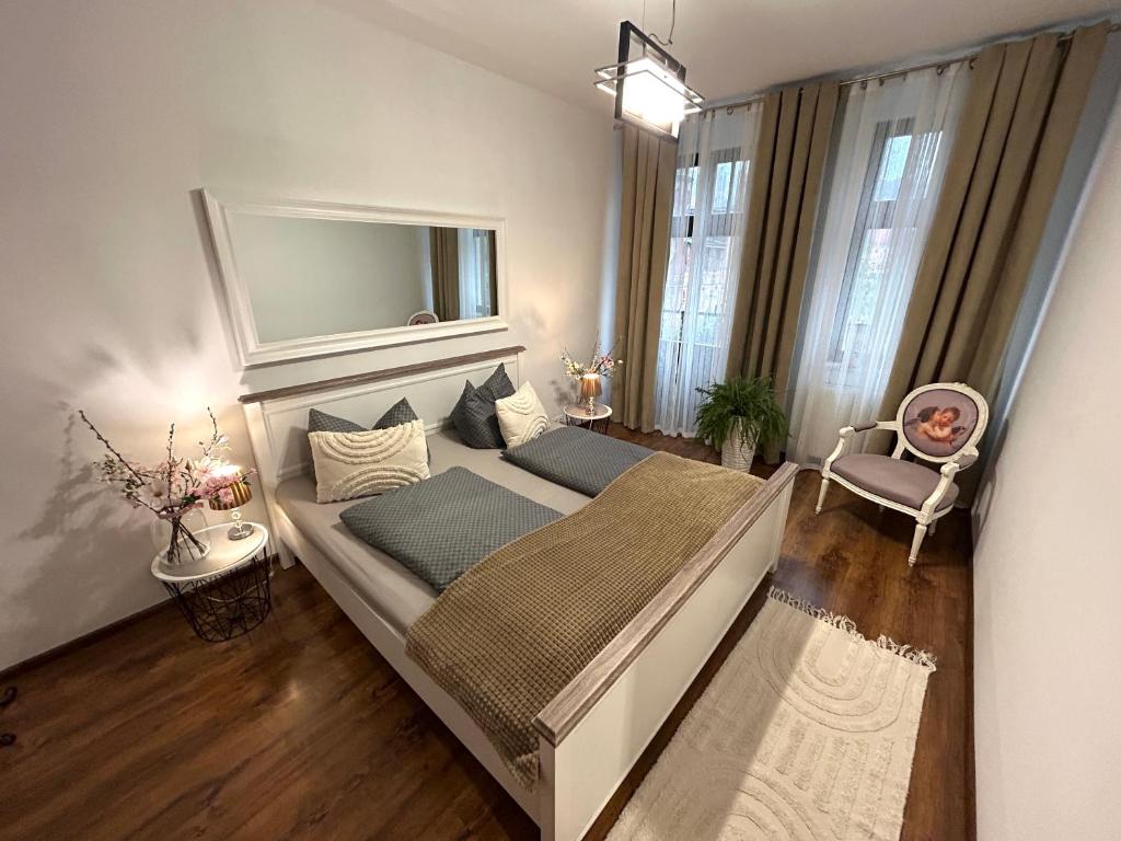 a bedroom with a bed with a mirror above it at An der Neiße in Görlitz